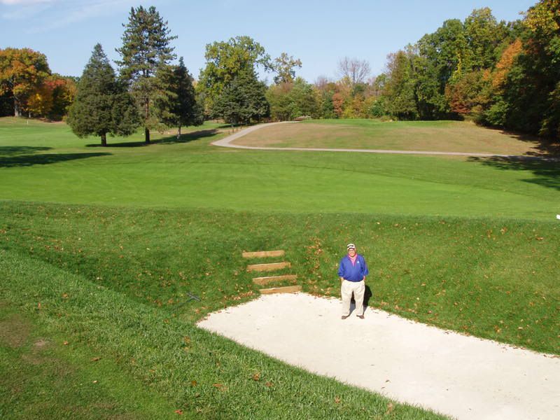 George bahto stands in the deep bunker of the Redan Hole at The Knoll Clubs West course, the par-3 third.